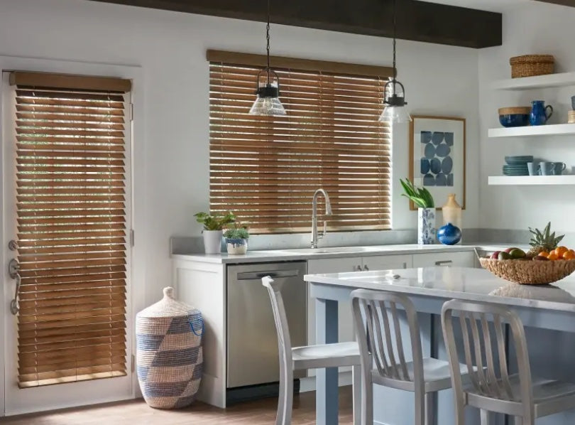 Customer installation - warm wood-tone 2 inch premium faux wood blinds in a kitchen