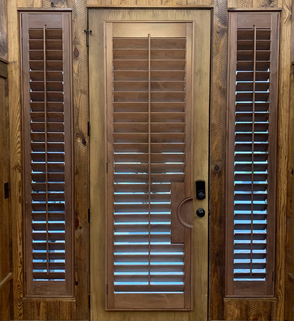Wood interior shutters on a door with sidelights