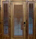 Wood interior shutters on a door with sidelights